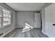 Bedroom with grey wood-look flooring, showing window and a doorway at 2773 Marcia Dr, Lawrenceville, GA 30044