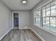 Bedroom featuring wood-look flooring, a large window, and access to the laundry room at 2773 Marcia Dr, Lawrenceville, GA 30044