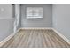 Bedroom featuring wood-look flooring and a window, offering plenty of natural light at 2773 Marcia Dr, Lawrenceville, GA 30044