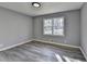 Bright bedroom with grey wood-look flooring and a double window offering natural light at 2773 Marcia Dr, Lawrenceville, GA 30044