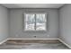 Bedroom with grey wood-look flooring and a window offering a view of the surrounding landscape at 2773 Marcia Dr, Lawrenceville, GA 30044