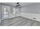 Bright dining area features modern lighting fixture, gray plank flooring, and access to the outdoor deck at 2773 Marcia Dr, Lawrenceville, GA 30044