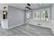 Bright dining area features modern lighting fixture, gray plank flooring, and access to the outdoor deck at 2773 Marcia Dr, Lawrenceville, GA 30044