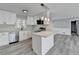 Modern kitchen with white cabinets, stainless steel appliances, light countertop, and stylish light fixtures at 2773 Marcia Dr, Lawrenceville, GA 30044