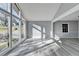 Light-filled living room with large picture windows, grey walls and wood-look floors at 2773 Marcia Dr, Lawrenceville, GA 30044