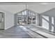 Living room with large windows providing ample natural light and wood-look floors at 2773 Marcia Dr, Lawrenceville, GA 30044