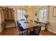 Inviting dining room with hardwood floors, elegant chandelier, and ample natural light from the two large windows at 4363 Bonaparte Dr, Tucker, GA 30084