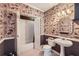 Quirky bathroom featuring funky wallpaper, a pedestal sink, and a shower/tub combination for a unique, eye-catching design at 5106 Vinings Estates Se Way, Mableton, GA 30126