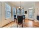 Sun-filled breakfast nook featuring hardwood floors, pendant lighting, and exterior access at 5106 Vinings Estates Se Way, Mableton, GA 30126