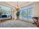 Open dining room area featuring large windows, a decorative chandelier and plush carpet at 5106 Vinings Estates Se Way, Mableton, GA 30126