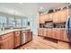 Spacious kitchen featuring light wood cabinets, modern appliances, and hardwood floors at 5106 Vinings Estates Se Way, Mableton, GA 30126