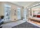 Bright office area with French doors, neutral walls, and plush carpet, flowing into dining room at 5106 Vinings Estates Se Way, Mableton, GA 30126