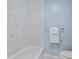Clean bathroom featuring white marble tile walls and a white tub at 80 Montre Nw Sq, Atlanta, GA 30327