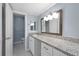 Bright bathroom featuring a granite countertop, vanity, and a decorative wooden framed mirror at 80 Montre Nw Sq, Atlanta, GA 30327