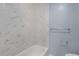 Clean bathroom featuring a tub with marble tile surround and modern fixtures at 80 Montre Nw Sq, Atlanta, GA 30327