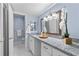 Well-lit bathroom featuring blue walls, granite countertop, and white marble tile flooring at 80 Montre Nw Sq, Atlanta, GA 30327