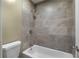 The bathroom features tiled walls, a soaking tub and updated fixtures at 80 Montre Nw Sq, Atlanta, GA 30327