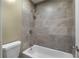 Tiled shower and tub in a bathroom with modern fixtures, creating a clean and stylish bathing experience at 80 Montre Nw Sq, Atlanta, GA 30327
