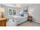 Light-filled bedroom with neutral walls and carpet, featuring a large window and stylish decor at 80 Montre Nw Sq, Atlanta, GA 30327