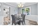 Cozy dining area featuring a gray color scheme, stylish wood floors, and a view of the kitchen, blending comfort and style at 80 Montre Nw Sq, Atlanta, GA 30327