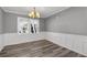 Inviting dining room featuring modern lighting, wainscoting and new hardwood floors at 80 Montre Nw Sq, Atlanta, GA 30327