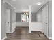 Bright entryway featuring hardwood floors, white wainscoting, chandelier, and a storm door at 80 Montre Nw Sq, Atlanta, GA 30327