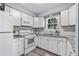 Efficient kitchen with white cabinets, granite countertops, stainless steel appliances, offering a clean and functional space at 80 Montre Nw Sq, Atlanta, GA 30327