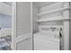 Convenient laundry area featuring a washer, shelving, and storage, optimizing space and utility within the home at 80 Montre Nw Sq, Atlanta, GA 30327