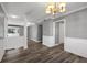 Open-concept living space featuring hardwood floors, updated lighting, white wainscoting, and neutral paint at 80 Montre Nw Sq, Atlanta, GA 30327