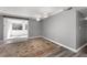 View of a neutral living room with wood flooring, white trim, and large rug, offering a bright and open space at 80 Montre Nw Sq, Atlanta, GA 30327