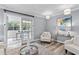 Living room featuring a sofa, chairs, and glass doors leading to a sunroom at 80 Montre Nw Sq, Atlanta, GA 30327