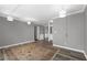 Open concept living space with neutral gray walls, hardwood floors, and stylish lighting fixtures at 80 Montre Nw Sq, Atlanta, GA 30327