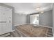 Entryway with white door leads to spacious living area featuring neutral paint, wood floors, and a decorative rug at 80 Montre Nw Sq, Atlanta, GA 30327