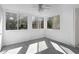 Light-filled sunroom with carpet, ceiling fan, and multiple windows showcasing wooded views, great for relaxation at 80 Montre Nw Sq, Atlanta, GA 30327