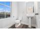 Modern half bath with pedestal sink, toilet and window with a view of a pond at 139 Jameson E Dr, Acworth, GA 30102