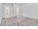 Spacious bedroom with carpet flooring, a neutral color scheme, and multiple doorways at 139 Jameson E Dr, Acworth, GA 30102
