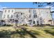 Modern townhome featuring a brick facade, gray siding, multiple windows, and a well-manicured lawn at 139 Jameson E Dr, Acworth, GA 30102