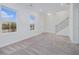 Large living room with neutral carpet, two windows, and a staircase at 139 Jameson E Dr, Acworth, GA 30102