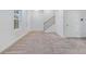 Open-concept living room with neutral carpet, staircase and bright windows at 139 Jameson E Dr, Acworth, GA 30102