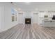 Open-concept living room featuring a fireplace, hardwood floors, recessed lighting, and a view into the kitchen at 139 Jameson E Dr, Acworth, GA 30102
