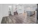 Open-concept space with hardwood floors, seamlessly connecting the living room, kitchen, and stairs to the upper level at 139 Jameson E Dr, Acworth, GA 30102