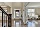 Entryway with hardwood floors leading to the front door and view into another living room space at 2515 Castlerock, Cumming, GA 30041