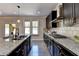 Modern kitchen featuring granite countertops, stainless steel appliances, and a center island at 2515 Castlerock, Cumming, GA 30041