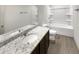Bathroom featuring granite countertops, a soaking tub, and modern fixtures at 3671 Salvia Dr, Buford, GA 30519