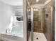 Bathroom featuring a soaking tub and enclosed glass shower at 3671 Salvia Dr, Buford, GA 30519