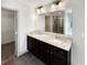 Bathroom featuring double sinks, granite countertops, and a glass-enclosed shower at 3671 Salvia Dr, Buford, GA 30519