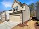 Side view of a two-story home with a two-car garage and well-maintained lawn at 3671 Salvia Dr, Buford, GA 30519