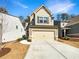 Charming two-story home featuring a two-car garage and well-maintained front yard with a freshly poured concrete drive way at 3671 Salvia Dr, Buford, GA 30519