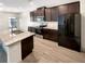 A kitchen featuring granite countertops, stainless steel appliances, and dark wood cabinetry at 3671 Salvia Dr, Buford, GA 30519