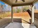 Covered patio featuring a ceiling fan and concrete base overlooking the backyard and wooded area at 3671 Salvia Dr, Buford, GA 30519